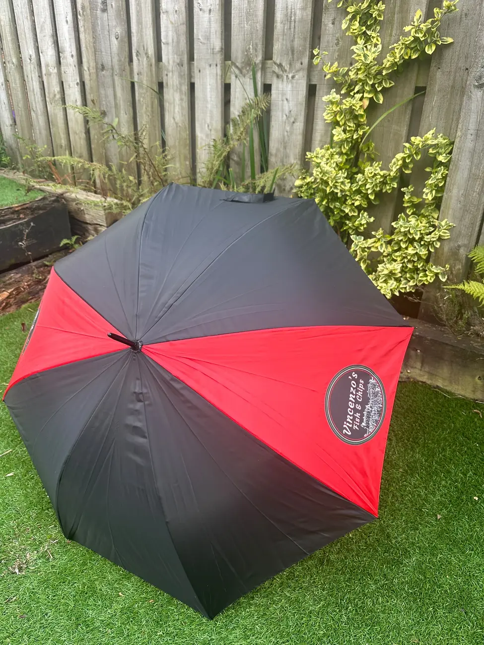The real black and red Vincenzo's umbrella opened outdoors